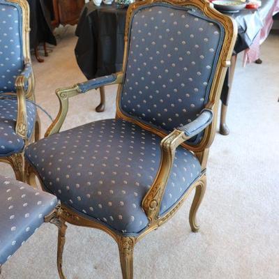 Antique arm chairs with blue upholstery and carved wood designs in Art Deco style
