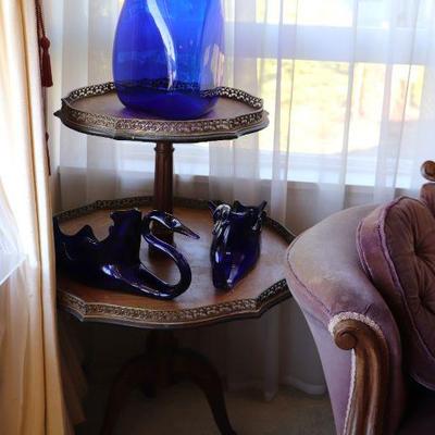 Antique wood two tier accent display table. Blue glass art pieces. 