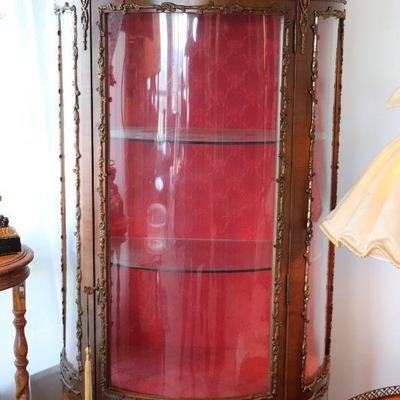 Antique Victorian era display cabinet with curved glass front.