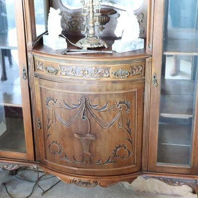 Gorgeous antique display cabinet with mirrors and detailed carvings. Antique art deco lamp. Vintage decor. 