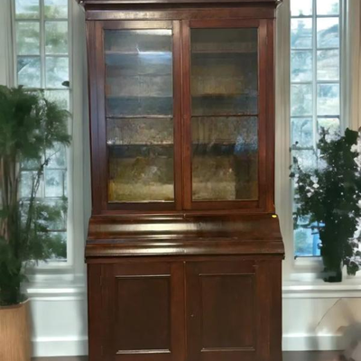 English Carved Mahogany Secretary Bookcase, 19th c., the carved floral crown over double mullioned glazed doors, above a rounded drop...