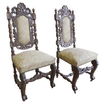 Pair of 19th c Richly Carved Renaissance style Chairs. Brocade Tapestry Upholstery on casters. Good condition. 19"x18"x44"