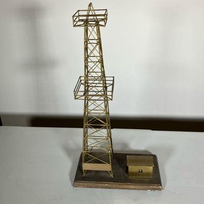 BRASS OIL WELL MODEL | A brass model of an oil well and shack mounted on an oak base. There are three brass plaques with it. One is...