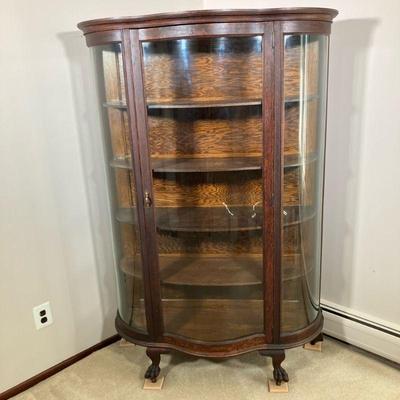 OAK SERPENTINE CHINA CLOSET | Oak China Closet with serpentine glass front door and bowed glass on sides. Has four shelves and front paw...
