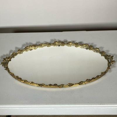 VINTAGE BRASS MIRROR PLATEAU | Heavy Raised brass flowers and leaves decoration circling the mirror tray. Felt lined on underside. - l....