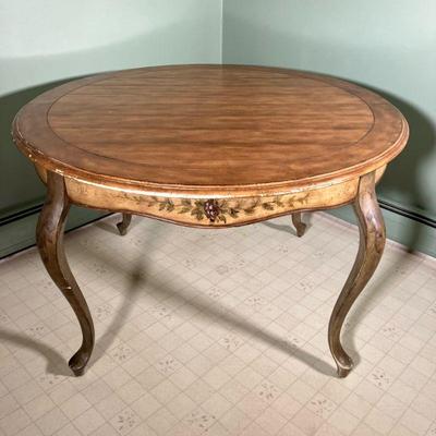 FRENCH COUNTRY PAINTED TABLE | A Round Table with a paneled light wood finish top with intentional age marks. The apron is painted an...