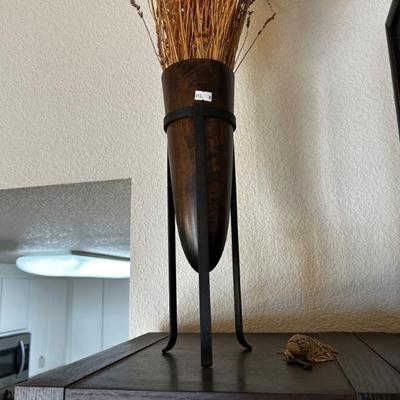 wooden vase in wrought iron stand 