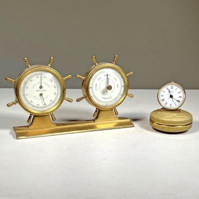 (2PC) CLOCKS & WEATHER ITEMS | Including a ships wheel weather station and a Seth Thomas travel clock. - l. 10 x h. 5 in (largest) 