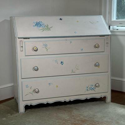 WHITE PAINTED FALL-FRONT DESK | Drop front slant lid desk painted with floral details. Having two drawers at the bottom and a pullout...