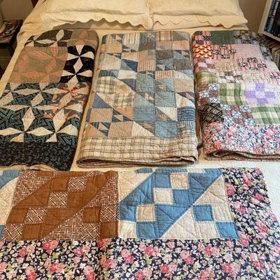 Nice assortment of well loved quilts 