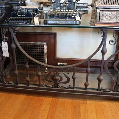 Antique wrought iron glass topped table, vintage typewriters, antique cash register