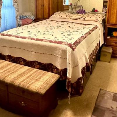 Queen bed and mattress with surrounding shelves and platform has drawers all the way around.