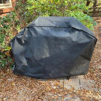 Charbroil Grill w/four burners and propane tank shown with cover