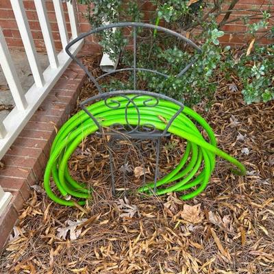 Freestanding metal hose roll-up and garden hose