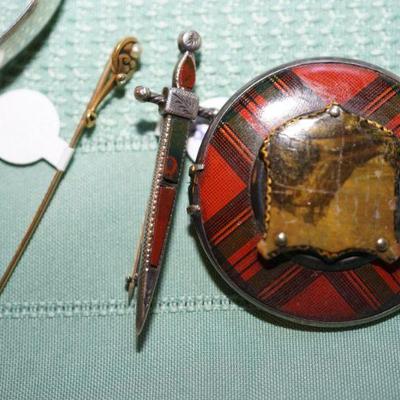 small scottish agate sword pin. 
14kt gold stick pin with diamond chip. sterling enamelled scottish pin.