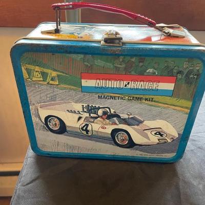 Vintage lunch box with thermos and toy