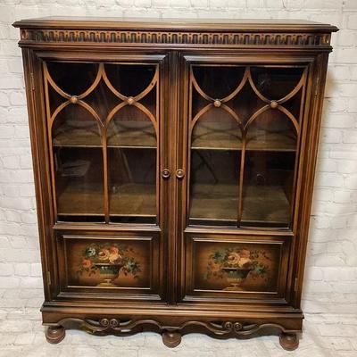 JIFI705 Display Cabinet	A small display cabinet featuring a painted floral design and decorative arched wood borders over glass
