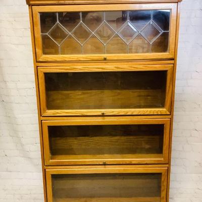 GRLE303 Mid-Century Oak Barrister Bookcase	Bookcase is solid with 4 shelves.Â On the right side there is a split in the wood.Â Cabinet is...