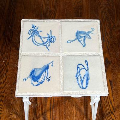 EQUESTRIAN TILE TABLE | Having four blue and white horse-themed painted tiles, set into a frame on a scrolled wrought iron white painted...