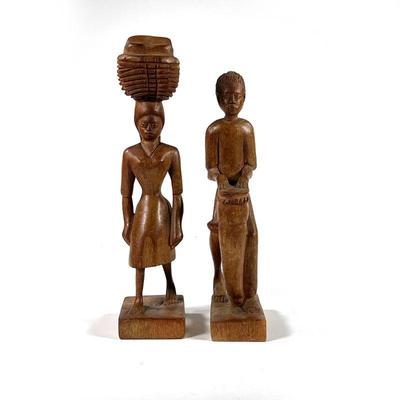 (2PC) E. JEANTY WOOD CARVINGS | Hatian figures. Including a male figure playing a drum and a female figure carrying a basket on her head....