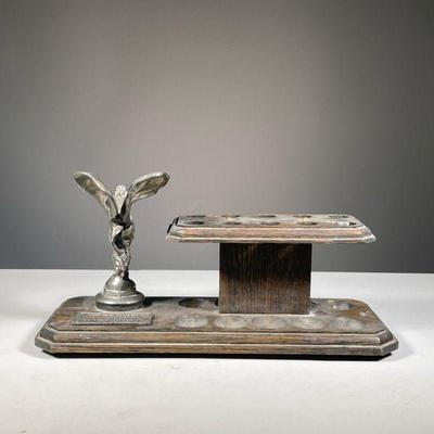 ROLLS ROYCE PIPE STAND | Rolls Royce hood ornament mounted on a wooden pipe rack/stand. - l. 15 x w. 6 x h. 8 in
