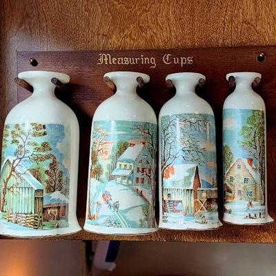 Vintage measuring cups on rack
