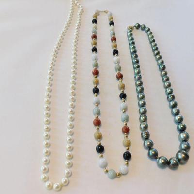 Tahitian pearl strand on the right (irregular) with 14k clasp.