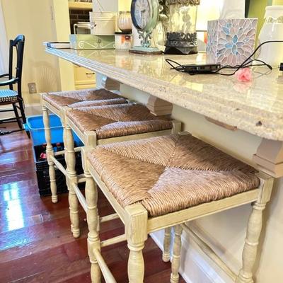 bar, 3 stools with cabinets, drawers on other side