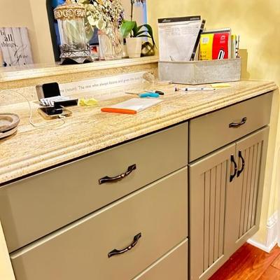 cabinet, drawers, counter top with 3 stool bar on other side