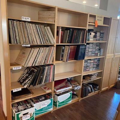 book shelves filled with record albums, cds, dvds, and more!