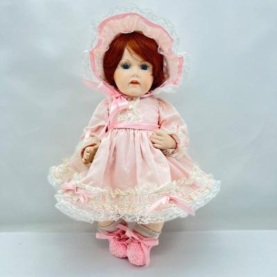 Sweet Little Girl 16â€Porcelain Doll. She is jointed has auburn hair and bright blue eyes