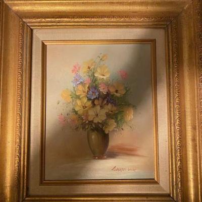 Two  of a pair of matching size and frame floral oil Paintings