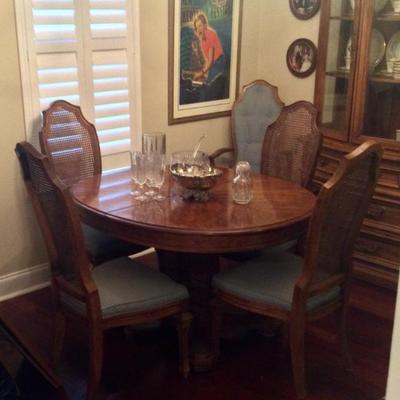 Dining table has four regular chairs and two captains chairs, table also has two additional leaves and table pad