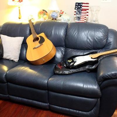 Green sofa with recliners, guitars