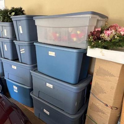 Holiday items still in bins, including 2 trees and several wreaths 