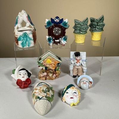 CERAMIC WALL POCKETS | Hanging ceramic wall pockets including; plants, birds, bird houses, clocks, a baker, and other busts. - l. 4 x w....