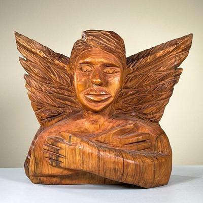 ANGEL CHAINSAW CARVING | Chainsaw woodcarving of cross-armed person with angel wings. Carved â€œR.A.â€. - l. 23 x w. 10.5 x h. 19 in
