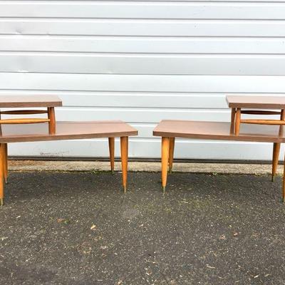 REEM234 Mid-Century Two Tier End Tables	Matching pair of 1960's-1970's veneer end tables. Both show some wear.Â 
