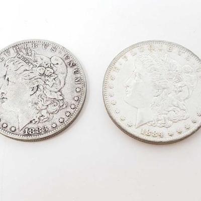 #218 â€¢ 1884-O And 1883 Morgan Silver Dollars
