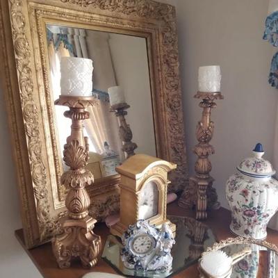 Gorgeous gold-framed mirror, candle stands, ginger jar, mirror tray, comb and mirror set, and clocks