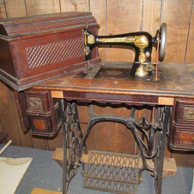 Antique Singer treadle sewing machine with cabinet