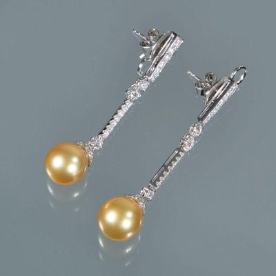 PAIR PEARL AND DIAMOND DROP EARRINGS | Having hard links set with melee diamonds each suspending a round champagne-colored pearl...