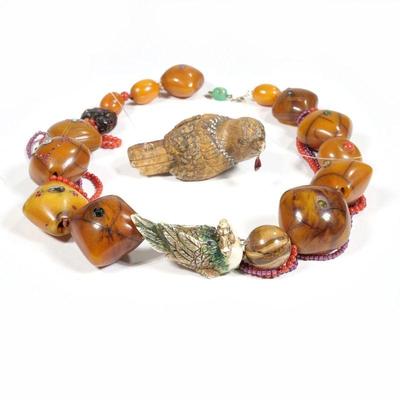 UNUSUAL ASIAN CARVED BIRD & JEWELED AMBER NECKLACE | Designed as variously shaped large amber beads (34 x 37 x 25 mm., largest) each...