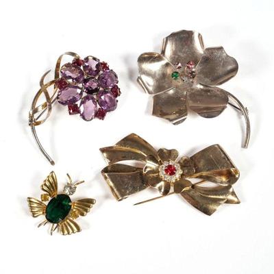 (4pc) STERLING BROOCHES | Vermeil / gold-tone sterling silver fashion pins, including two flower pins, a Coro bow-form pin, and a...