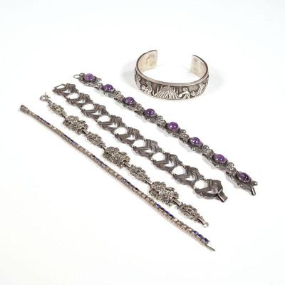 (5pc) STERLING BRACELETS | Including a Taxco amethyst cabochon bracelet (l. 7.25 in.), an LL. BCT sterling cuff bracelet with figures, a...