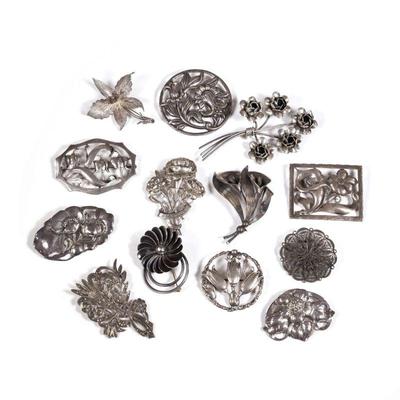 (13pc) STERLING FLOWER PINS | Sterling silver flower-shaped brooches and pins, each marked or tested to sterling, including: a Paglia...