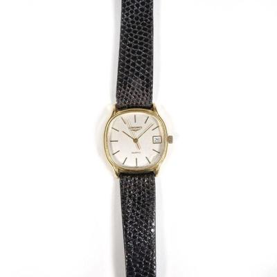 VINTAGE 18K GOLD LONGINES WRISTWATCH | Having a silvered dial with baton numerals and a date subwindow, 18k yellow gold case (32mm) with...