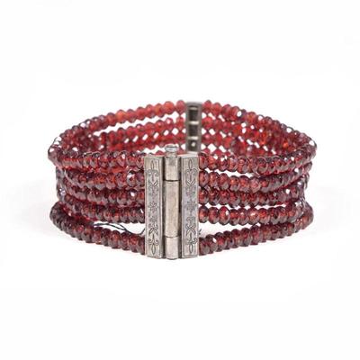 GARNET FACETED BEAD & MIXED METAL BRACELET | Having five strings of garnets on a chased engraved antique silver clasp
