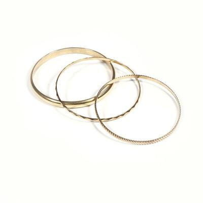(3pc) 14K GOLD BRACELETS | Including a Hollow smooth gold bracelet, (10.9g), a twisted rope form bracelet (7.6g), and a textured call...