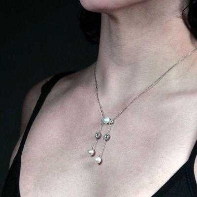 J.E. CALDWELL NATURAL PEARL & DIAMOND NECKLACE | Designed as central plaque mounting a natural button pearl flanked by six .20 ct...